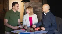 uczestnicy studiów podyplomowych pracujący w grupie nad projektem