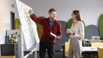 Prawo i zarządzanie | Studia I stopnia w Chorzowie | Uniwersytet WSB Merito Chorzów: studenci omawiają dane zapisane na tablicy