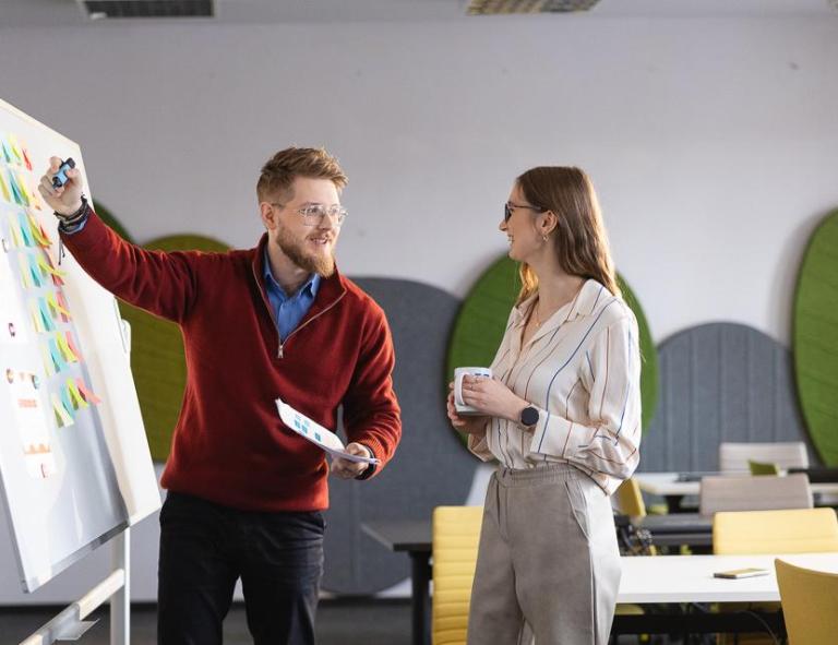 Career Office | WSB Merito University in Chorzów: studenci omawiają dane zapisane na tablicy