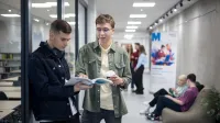 Prawo w energetyce | Uniwersytet WSB Merito w Gdańsku: Dwóch chłopaków rozmawia na uczelni