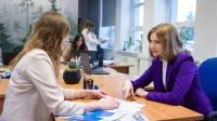 Bankowość 4.0 i finanse cyfrowe | Studia I stopnia w Gdańsku | Uniwersytet WSB Merito w Gdańsku: Rozmowa przy biurku dwóch kobiet ubranych biznesowo