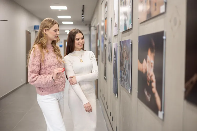 Administrowanie nieruchomościami | Studia II stopnia w Gdańsku | Uniwersytet WSB Merito w Gdańsku: Dwie studentki oglądają galerię prac 