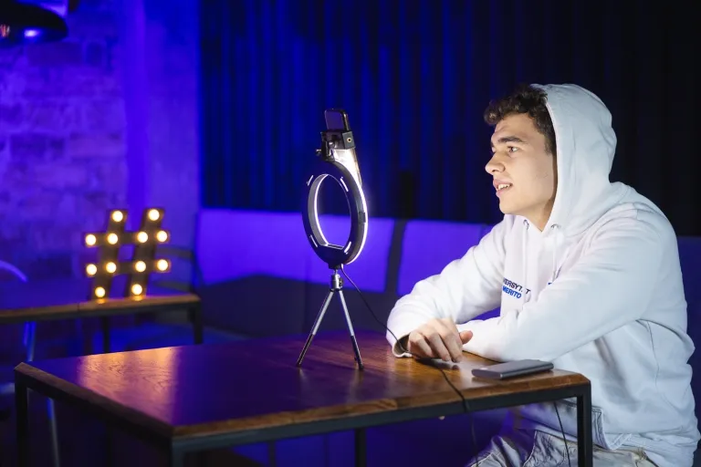 Film w mediach cyfrowych | Studia I stopnia w Gdańsku | Uniwersytet WSB Merito w Gdańsku: Student przy nagrywce na komórce