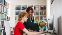 Edukacja zdrowotna | Studia podyplomowe w Gdyni | Uniwersytet WSB Merito Gdynia: Studentki przy ekranie monitora w bibliotece