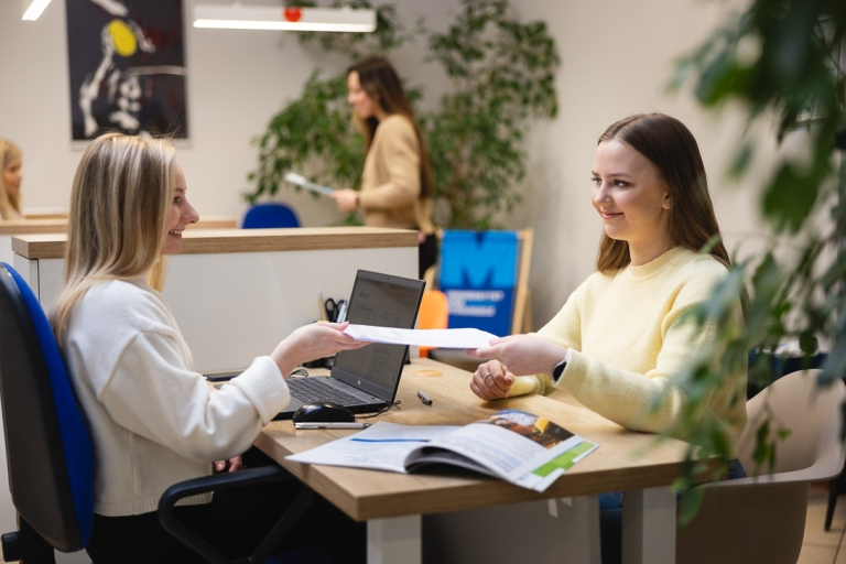 Pośrednictwo pracy | Uniwersytet WSB Merito Gdynia: Dwie kobiety załatwiają formalności na Uniwersytecie
