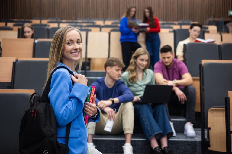 Zarządzanie sprzedażą | Studia I stopnia w Łodzi | Uniwersytet WSB Merito Łódź: Grupka studentów siedzi i rozmawia w auli.