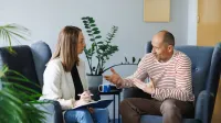 Dietetyka pediatryczna | Studia II stopnia w Opolu | Uniwersytet WSB Merito Opole: Główna grafika: Opole - studia II stopnia- Dietetyka: Dietetyka pediatryczna - studenci siedzą na fotelach na korytarzu uczelni i rozmawiają