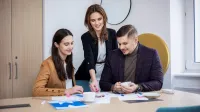 Inżynieria oprogramowania w JavaScript (TypeScript) | Studia podyplomowe w Opolu | Uniwersytet WSB Merito Opole: Główna grafika: Opole - studia podyplomowe -Inżynieria oprogramowania w JavaScript (TypeScript) - uczestnicy studiów podyplomowych analizują wspólnie treści z kartek leżących na biurku