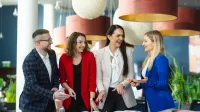 Mentor Practitioner | Szkolenia i kursy w Poznaniu | Uniwersytet WSB Merito w Poznaniu: studenci stojący przy biurku