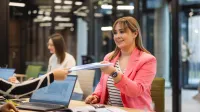 Business Intelligence – analiza danych | Studia podyplomowe w Szczecinie | Uniwersytet WSB Merito Szczecin: studentka podaje dokumenty w biurze