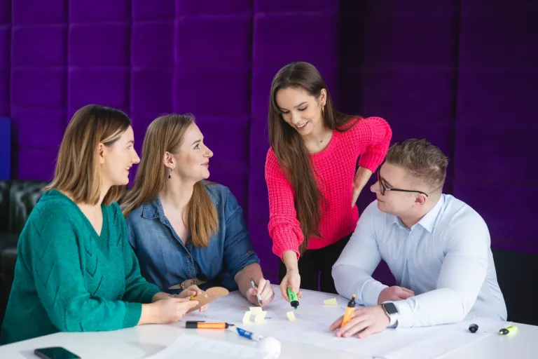 Prawo w HR | Studia I stopnia w Toruniu | Uniwersytet WSB Merito w Toruniu: Główna grafika: Toruń - studia I stopnia - grupa uśmiechniętych studentów przy projekcie